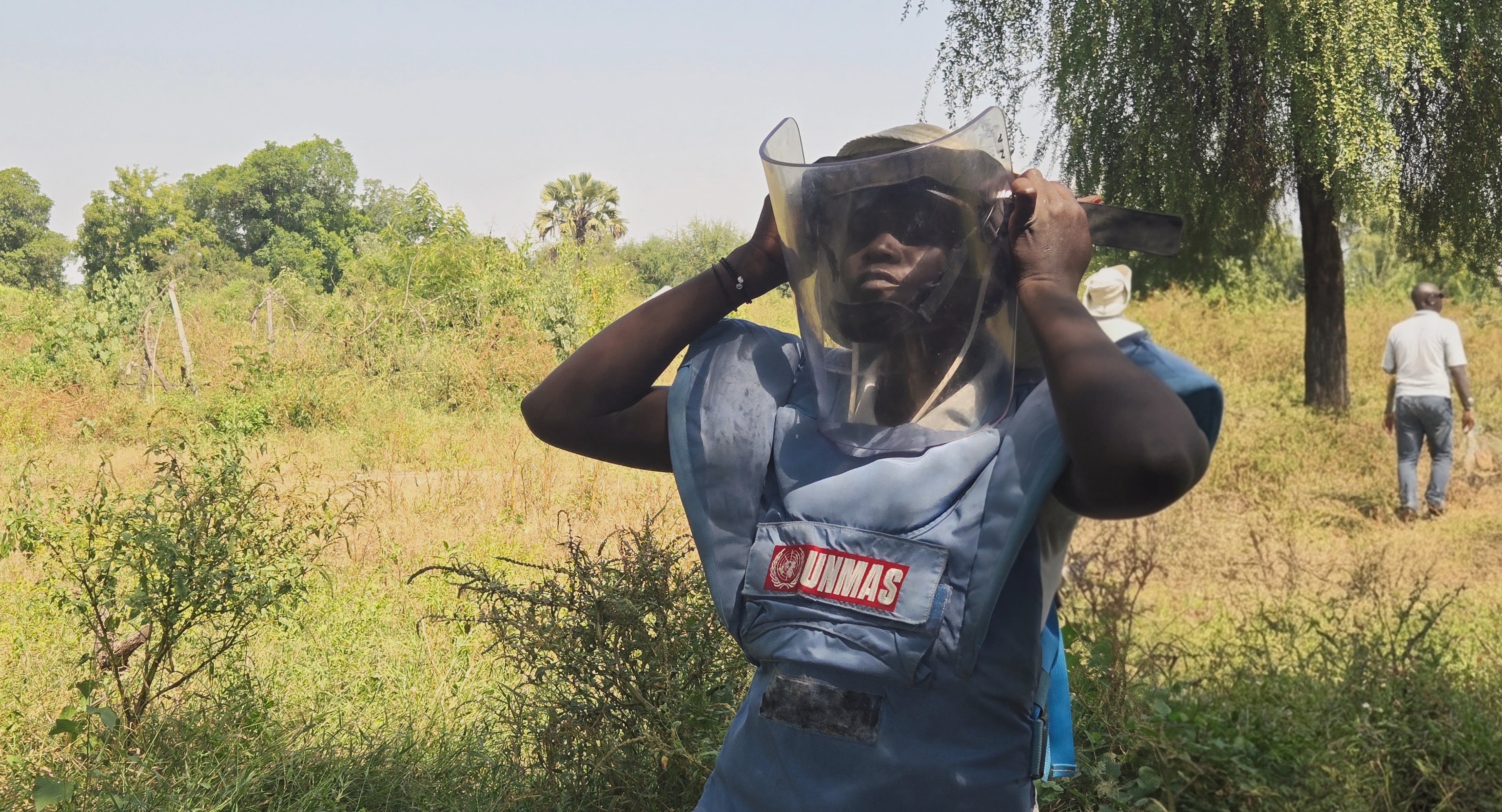 a female deminer with a protective mask