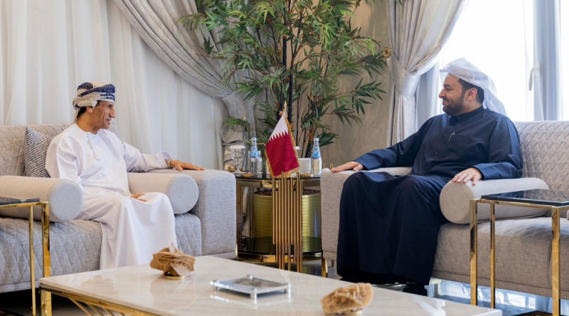 A person sitting in a chair next to a person

Description automatically generated