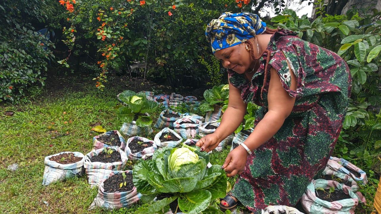 a woman is working in a garden