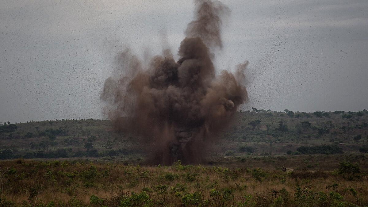 an explosion with smoke in a field