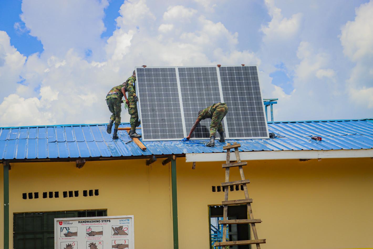 peacekeepers setting up solar panels