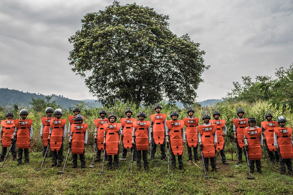 a group of deminers are standing in line
