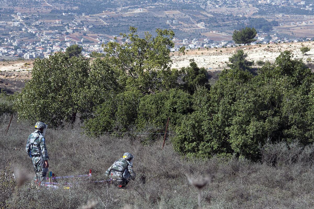A deminer pauses as he checks the ground in front of him along the Blue Line in the vicinity of Rmeish, south Lebanon.