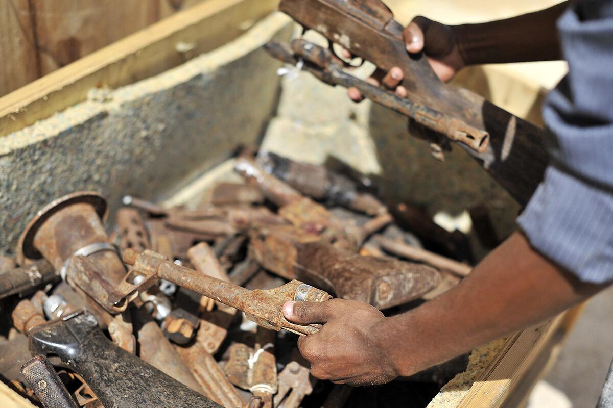 A Somali security officer inspects destroyed obsolete guns during a training of weapons destruction in Mogadishu, Somalia. The training was supported by the United Nations Assistance Mission in Somalia (UNSOM) and conducted by UNMAS. 