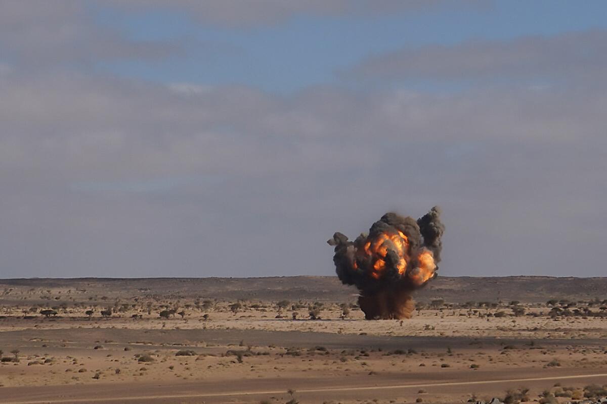 an explosion with smoke in a field