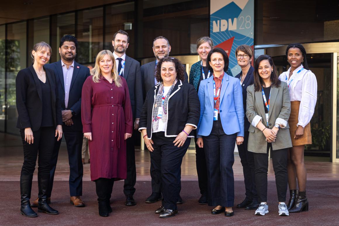 some people wearing formal clothings are standing together